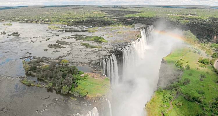 Aerial view of Victoria Falls with a rainbow.