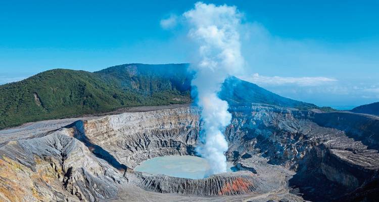 Poás Volcano with smoke rising from the crater.