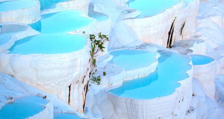 White travertine terraces with turquoise water pools.