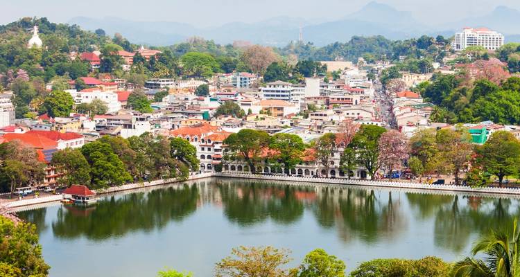 Panoramic view of Kandy city surrounding a serene lake with distant green hills