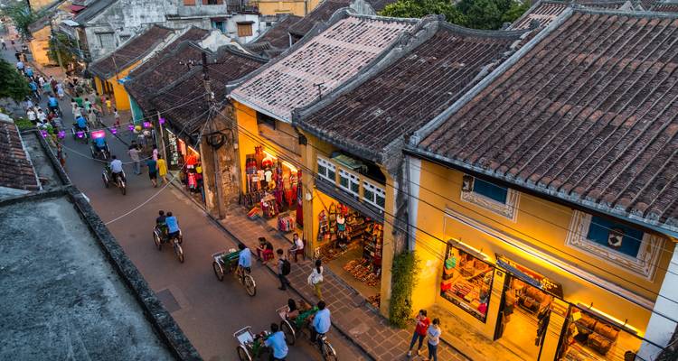 A vibrant street scene in Hoi An with bicycles and colorful buildings.