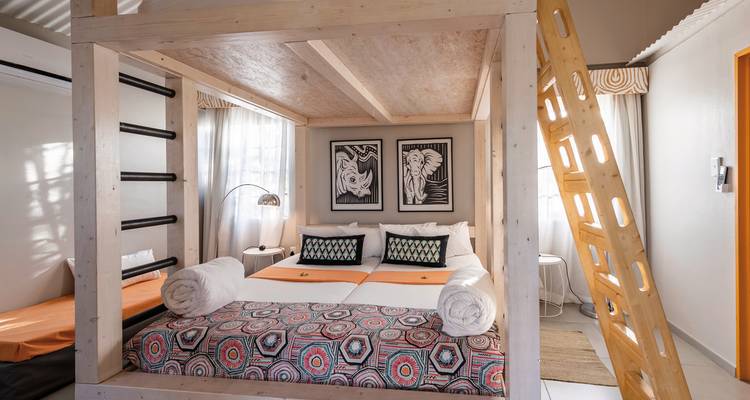 A cozy accommodation interior with an artistic bed arrangement.