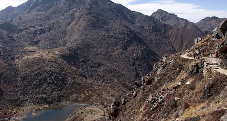 Mountains with a small lake nestled between rocky terrain.