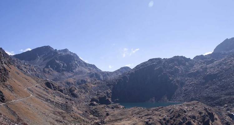 Mountain landscape with a lake surrounded by rocky terrain.
