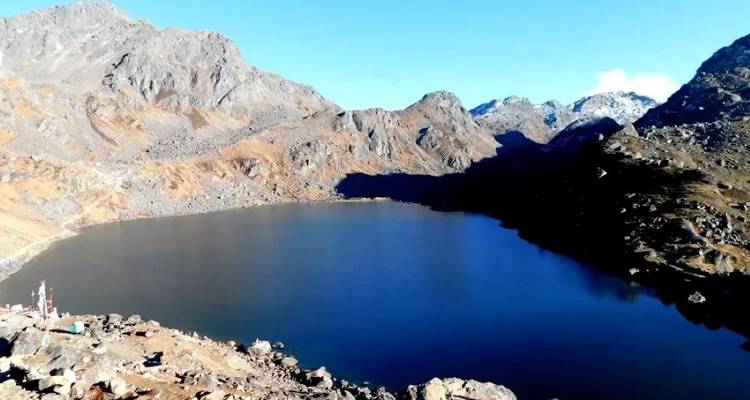 Blue high-altitude lake surrounded by mountains.