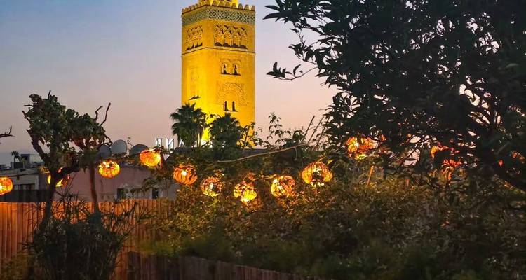 View of a city tower with lanterns in the foreground.