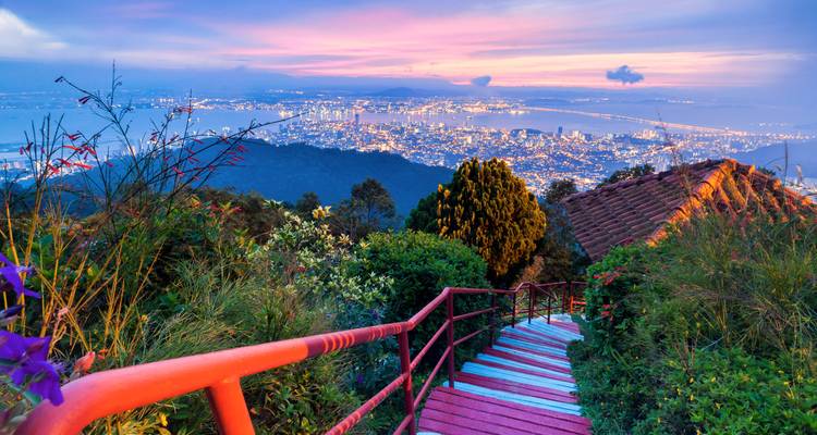 Hilltop view overlooking Penang city with vibrant skies.