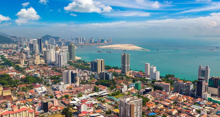 Aerial view of urban layout along Penang's coastline.
