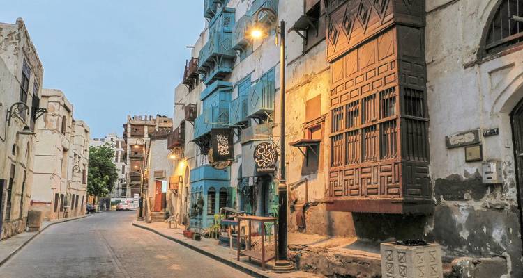 Historic street with traditional buildings and colorful windows.