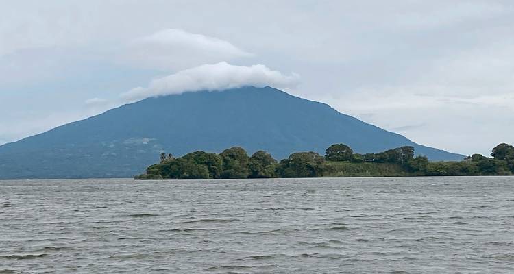 Distant hills and lake with a cloud-covered peak.