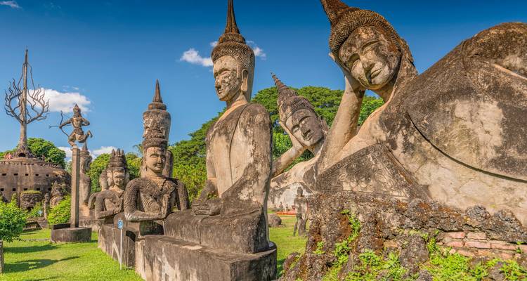 Buddha Park, Vientiane with statues under a blue sky.
