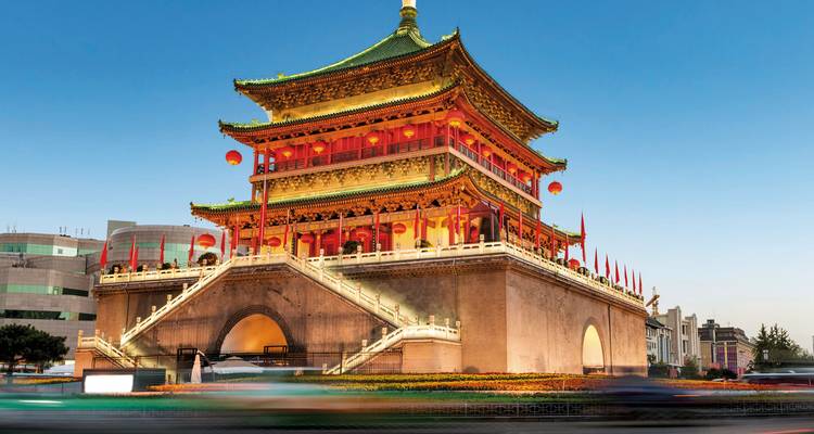 Beleuchtetes traditionelles chinesisches Gebäude in der Dämmerung.