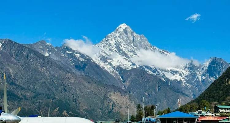 Snow-capped mountain view with blue sky.