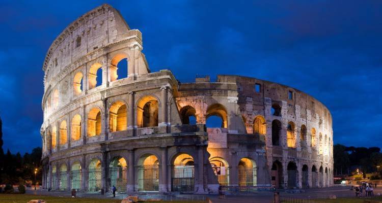 The Colosseum illuminated at night.