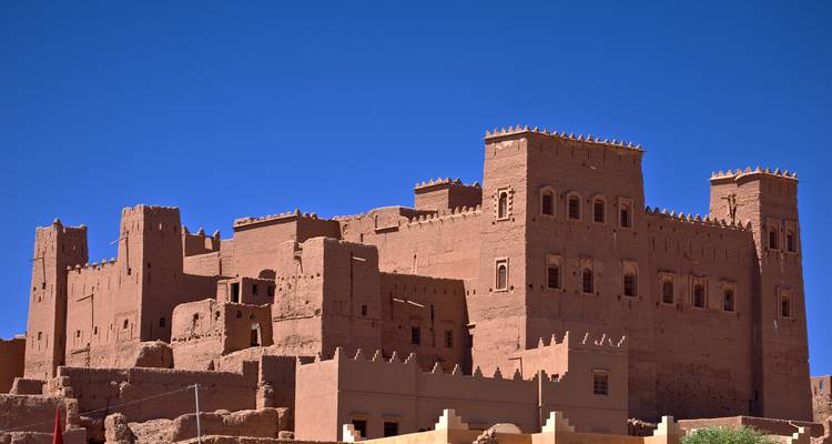 Traditional mud-brick fortress under a blue sky.