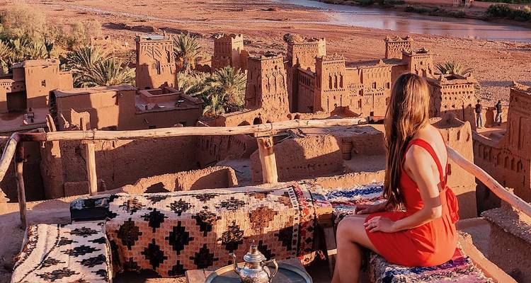 Overlooking a kasbah with a river in the background.