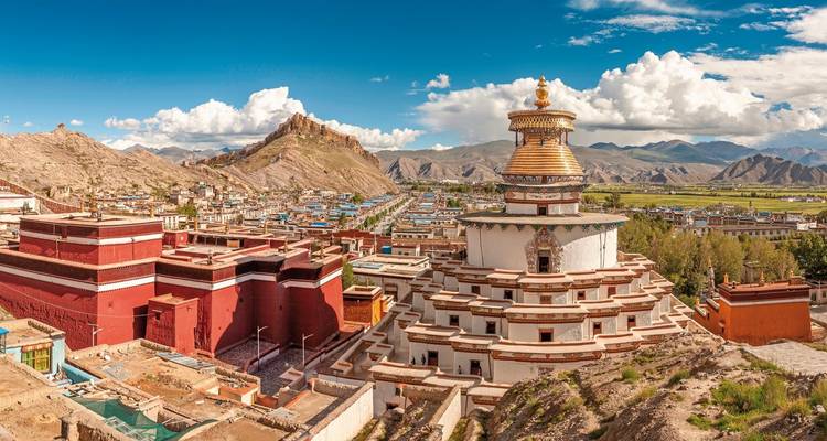 Panoramic view of a Tibetan town with a large stupa.
