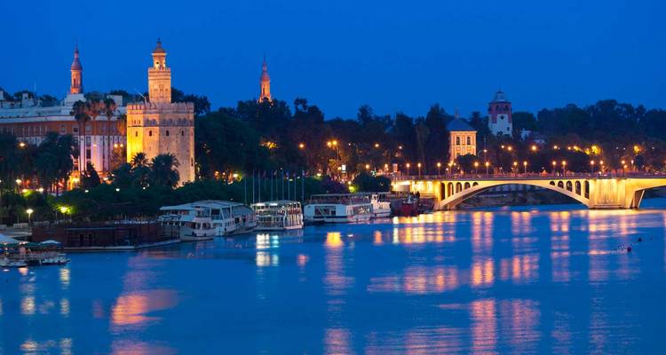 Night view of the Guadalquivir riverbank in Seville, Spain.