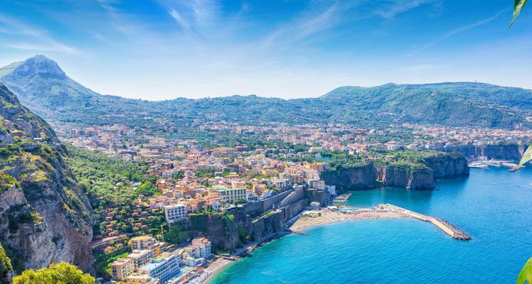 Coastal view of Sorrento with blue seas and lush greenery.
