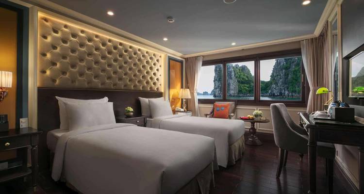 Luxurious hotel room with twin beds and view through a window