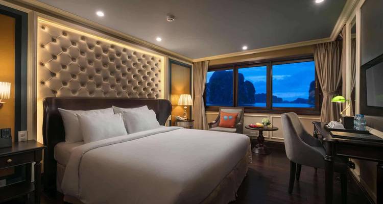 Luxurious hotel room in evening light with a large bed