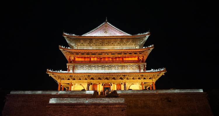 Illuminated traditional Chinese building at night.