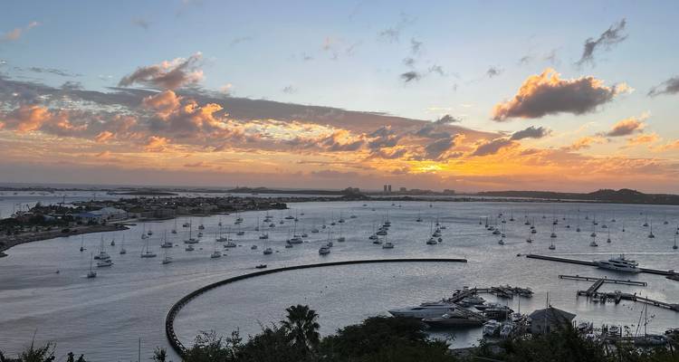 Sunset view over a marina filled with boats.
