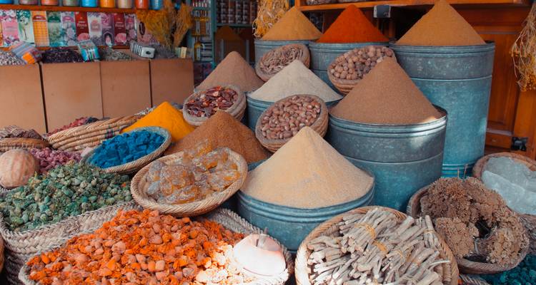 Various spices and goods on a market stall.