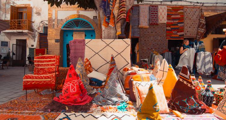 Colorful textiles and carpets displayed in a market.