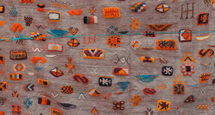 A close-up view of a traditional Moroccan carpet with colorful designs.