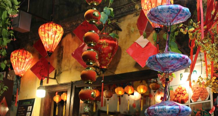 Colorful silk lanterns and festive decorations hang inside a shop in Hoi An’s old town.