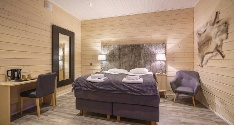 Modern hotel room with a comfortable bed and minimalist design.