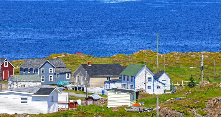 Coastal village with colorful houses beside the ocean.