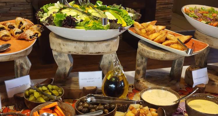 Buffettafel met verschillende gerechten en salades.