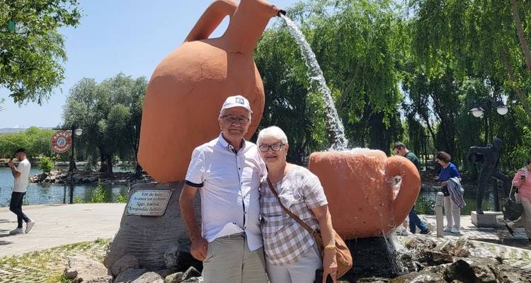 Pareja posando con una escultura de fuente única.
