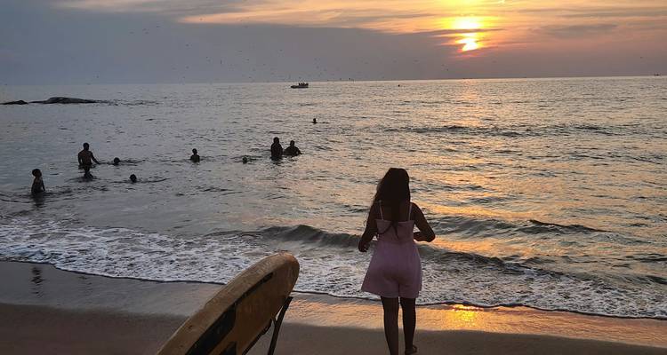 A person watching the sunset on the beach.