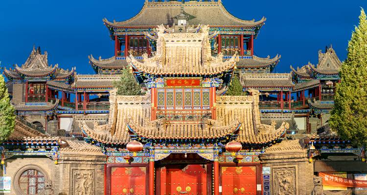 Traditional Chinese temple with intricate decorations at night.