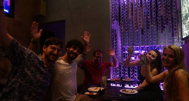 A group of people sitting indoors with a casual atmosphere.