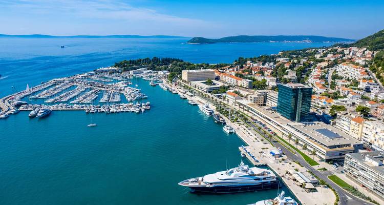 A marina with boats and a panoramic view of the coastline.
