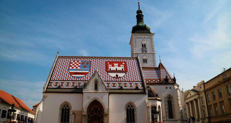 A historic church with a colorful tiled roof.