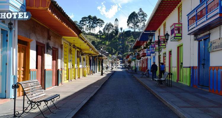 Colorful, traditional street with hotel sign in a quiet town.
