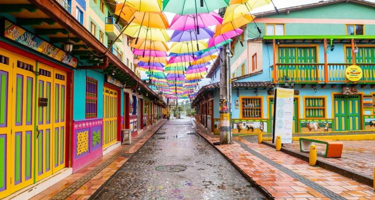 Street under vibrant umbrellas and colorful buildings.