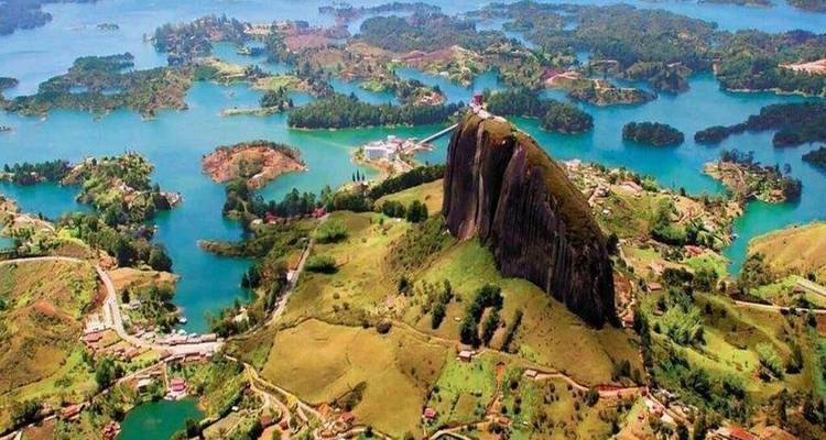 Aerial view of a reservoir and islands around a large rock.