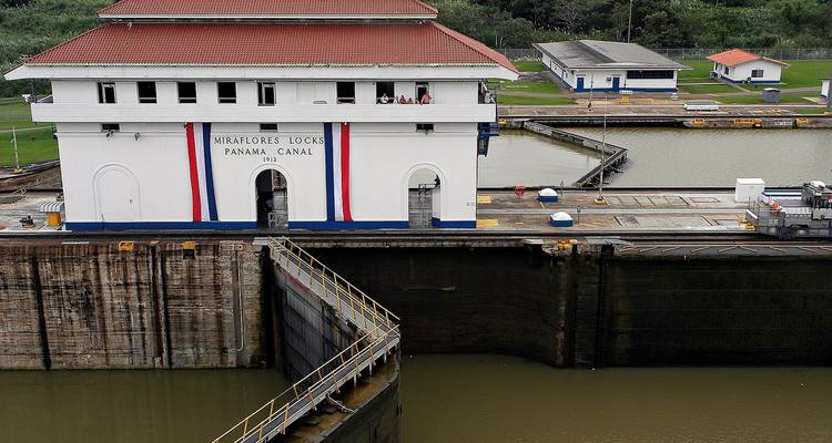 Partial view of the Miraflores Locks of the Panama Canal with people visible.
