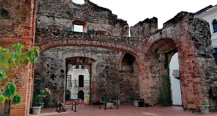 Old stone ruins of a building with visible brick and vegetation.