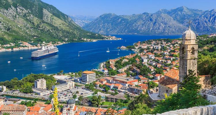 Stunning panorama over Kotor Bay with emerald waters, cruise ship and surrounding Dinaric Alps
