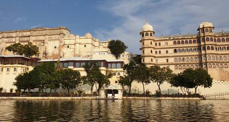 Große Palastanlage am Seeufer mit sichtbaren Booten.