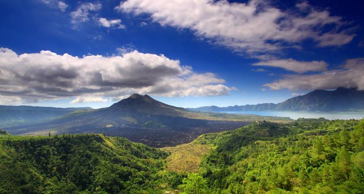 Mountainous landscape with lush greenery under a blue sky.