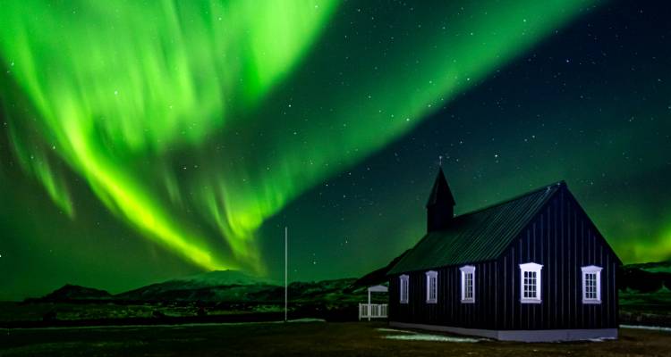 Northern lights over a black church.