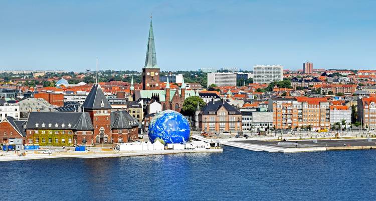 Aerial view of a city with a prominent church and globe decoration.